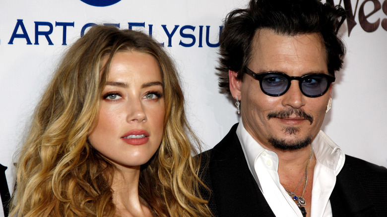 Johnny Depp smiling with Amber Heard