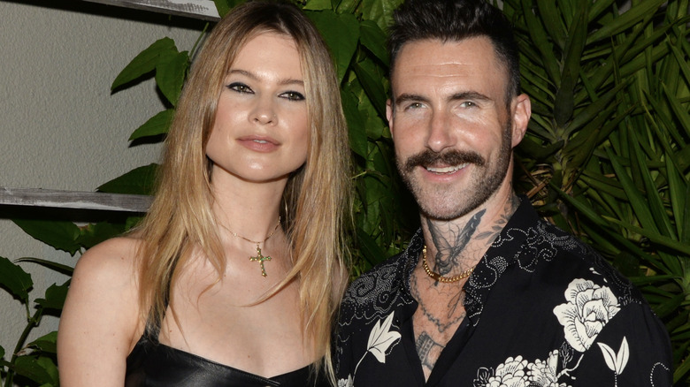 Behati Prinsloo and Adam Levine pose together