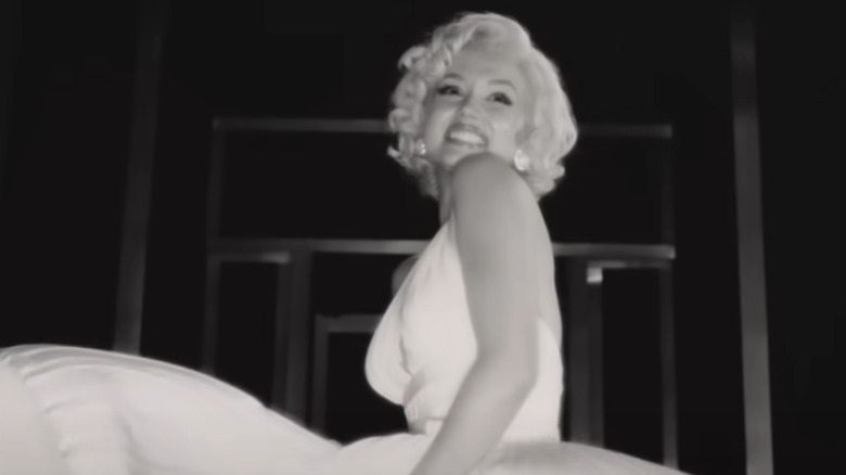 Ana de Armas as Marilyn Monroe smiles while recreating a scene from "The Seven Year Itch"