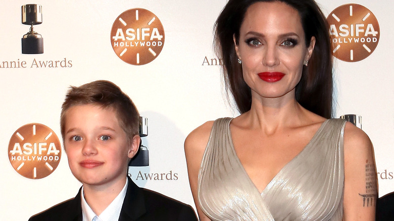 Shiloh Jolie-Pitt and Angelina Jolie posing