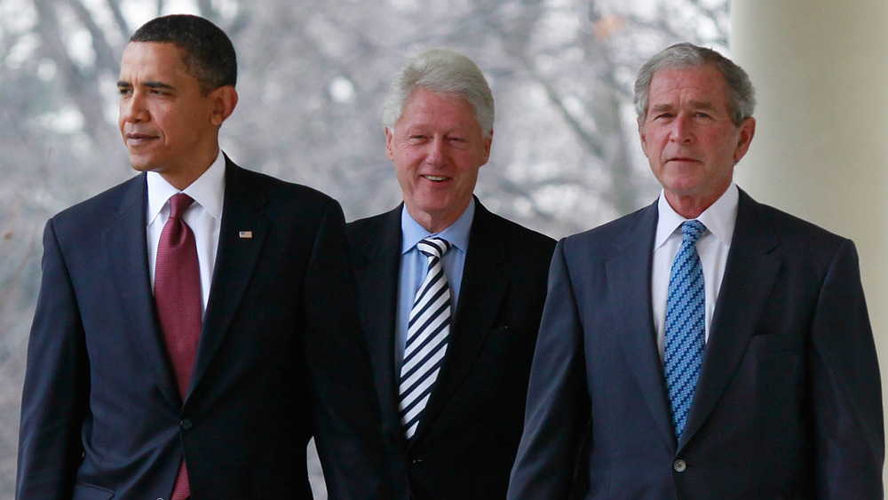 Former presidents Barack Obama, Bill Clinton, and George W. Bush walking