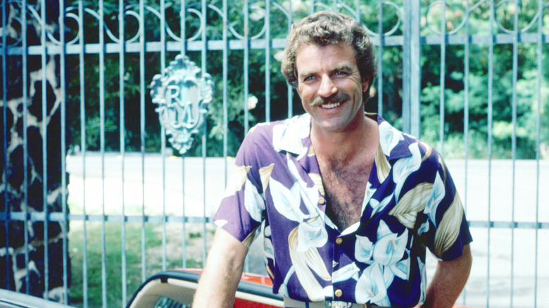 Tom Selleck poses in a convertible car