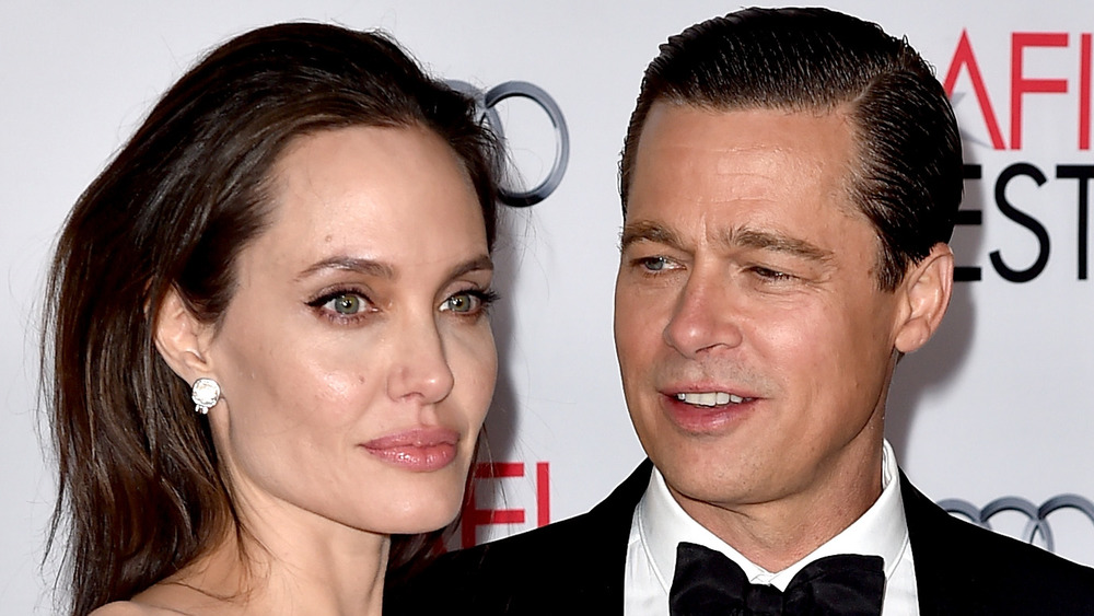 Brad Pitt looking at Angelina Jolie while on the red carpet