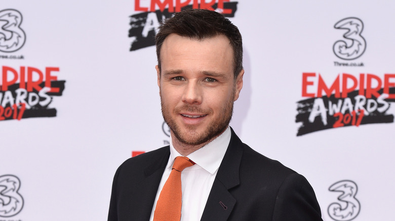 Rupert Evans smiling on red carpet