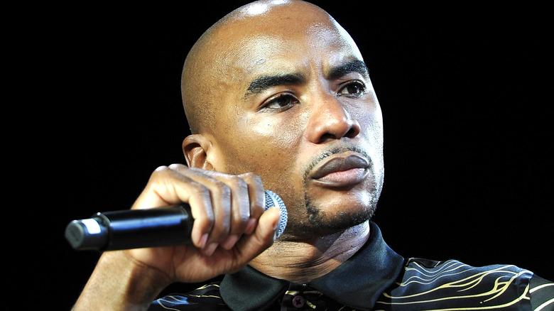 Charlamagne tha God holds a microphone