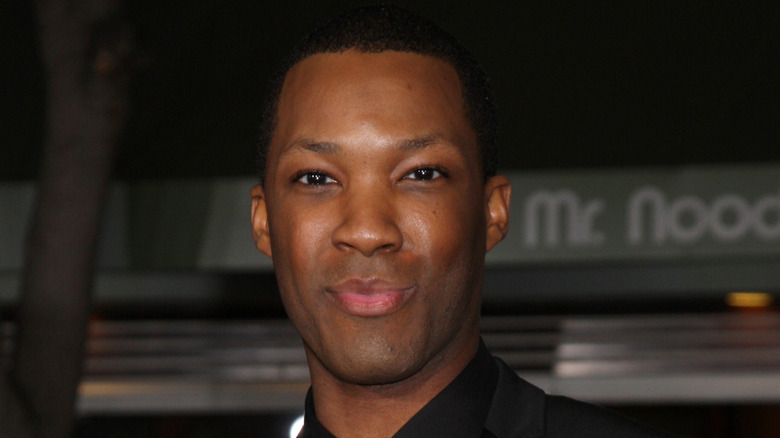 Corey Hawkins smiles on the red carpet