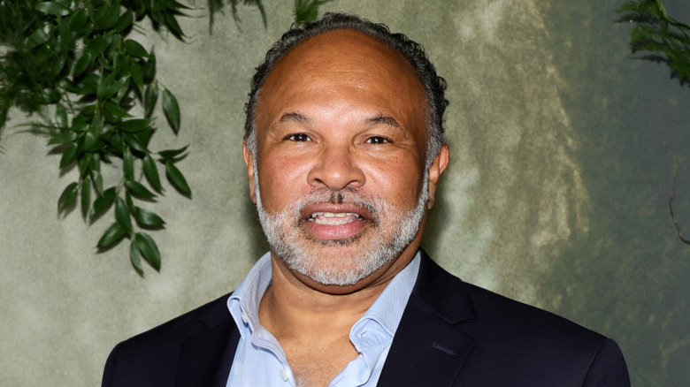 Geoffrey Owens smiles in a suit