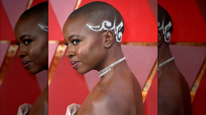 Danai Gurira with design painted on side of head