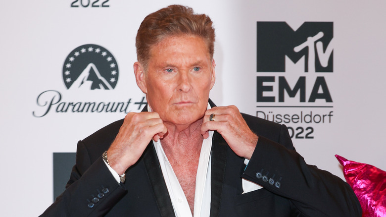 David Hasselhoff fixing the collar of his shirt