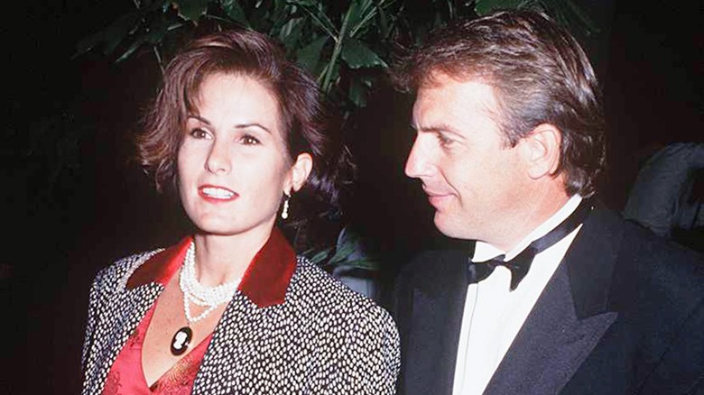 Kevin Costner stands next to Cindy Silva