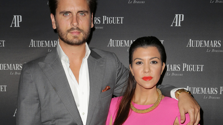 Scott Disick with his arm around Kourtney Kardashian