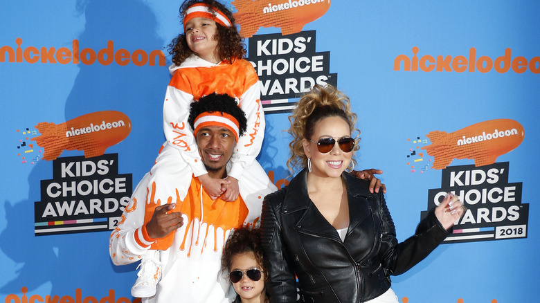 Nick Cannon and Mariah Carey posing with their children