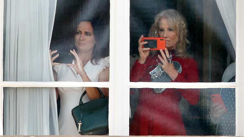 Stephanie Grisham taking photos with Kellyanne Conway