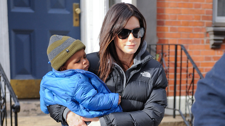 Sandra Bullock carries son Louis 