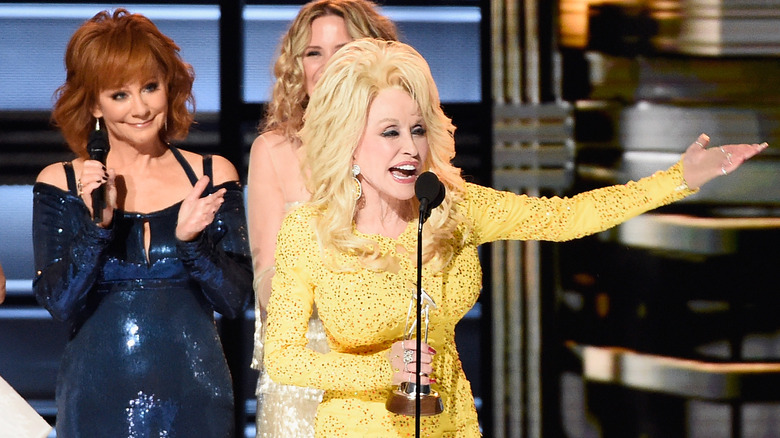 Reba McEntire claps for Dolly Parton