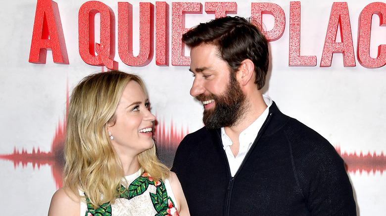 Emily Blunt and John Krasinski smile at a "Quiet Place" event