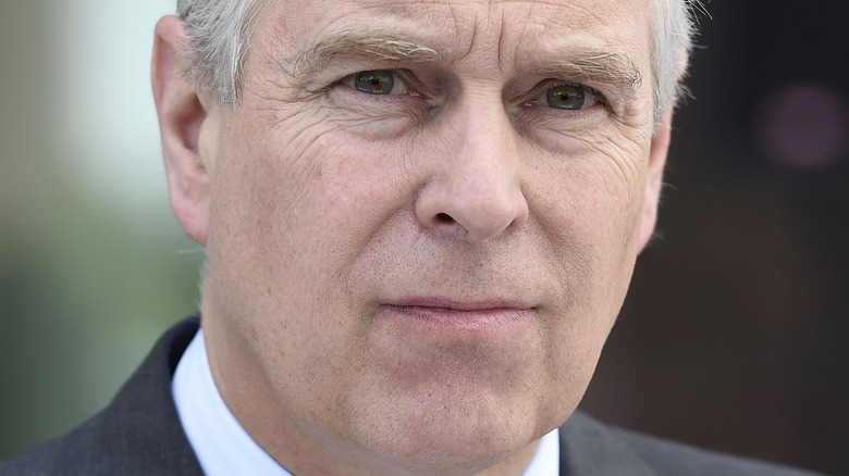 Prince Andrew at an event, looking serious