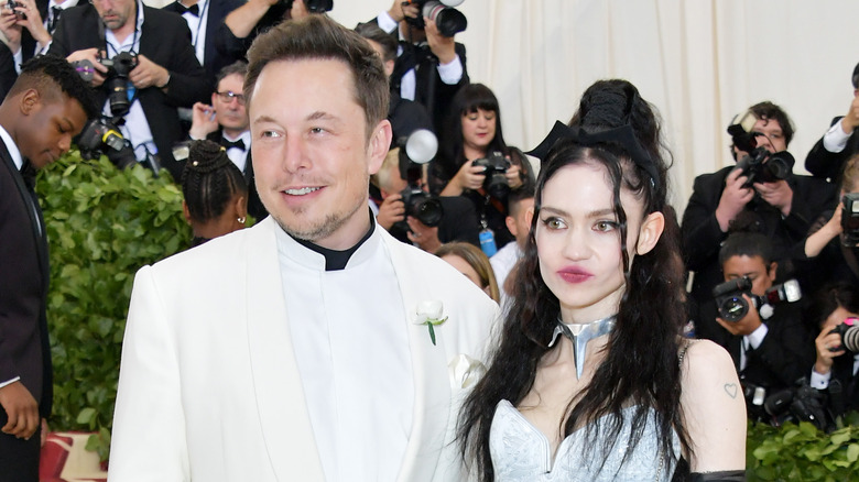 Elon Musk and Grimes smiling