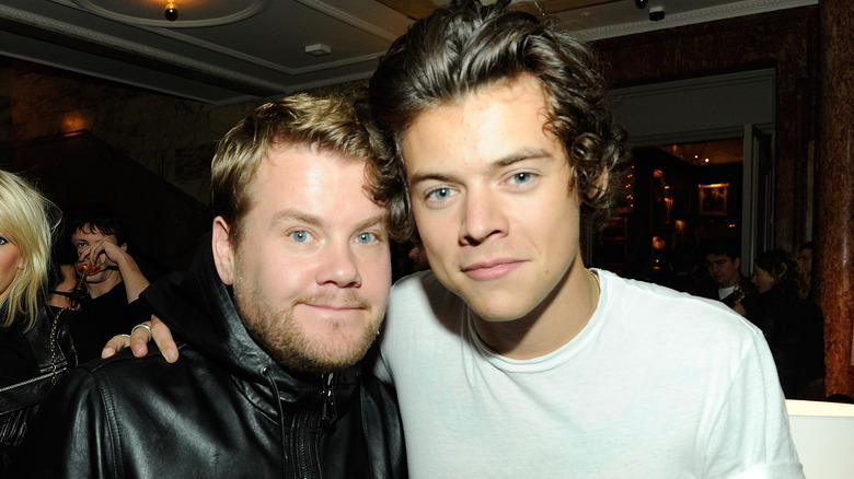 James Corden and Harry Styles posing in 2013