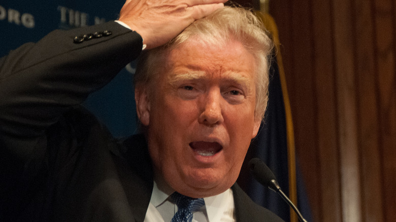 Donald Trump touching his hair