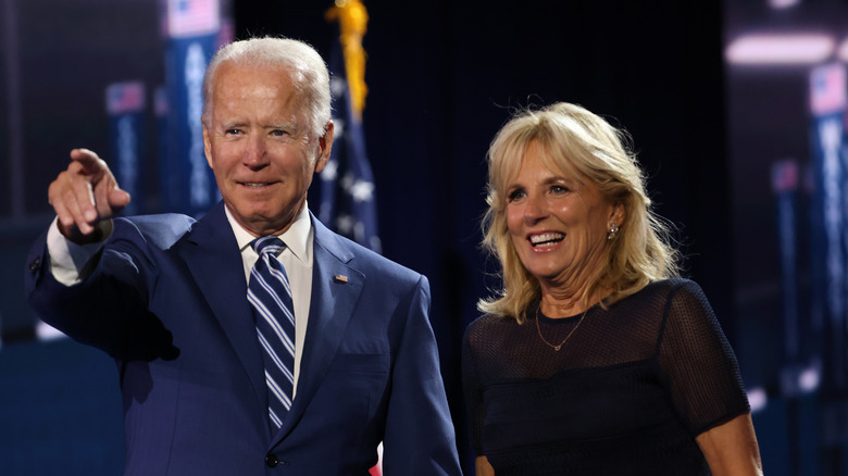 Joe Biden reacts onstage alongside his wife Jill Biden