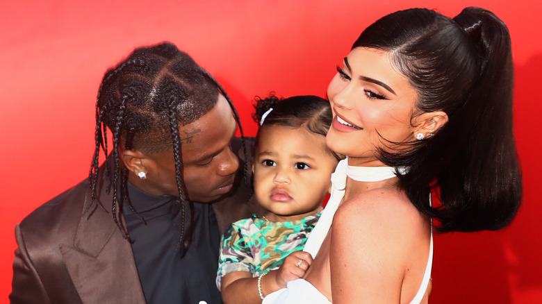 Travis Scott, Kylie Jenner, and Stormi smiling