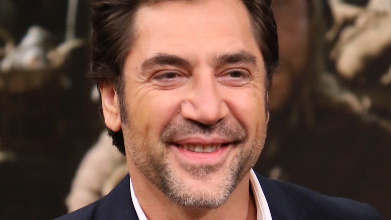 Javier Bardem smiling in dark jacket