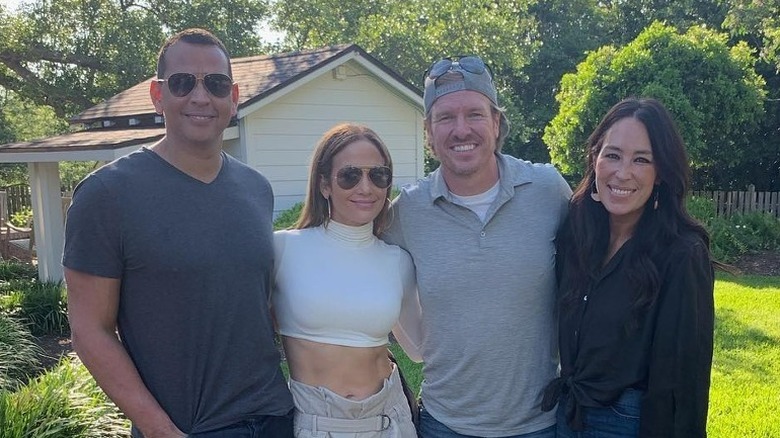 Jennifer Lopez and Alex Rodriguez posing with Chip and Joanna Gaines