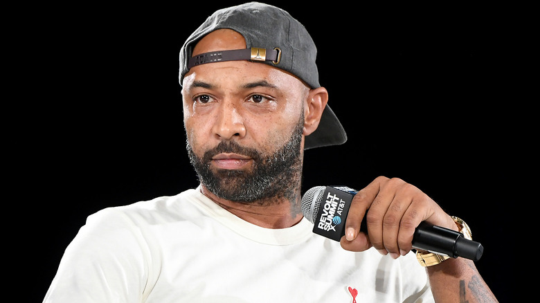 Joe Budden speaking into microphone