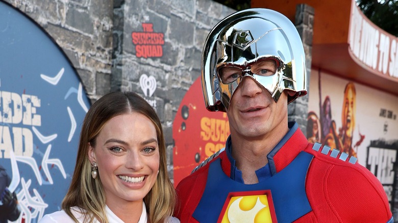 John Cena dressed as Peacemaker with Margot Robbie