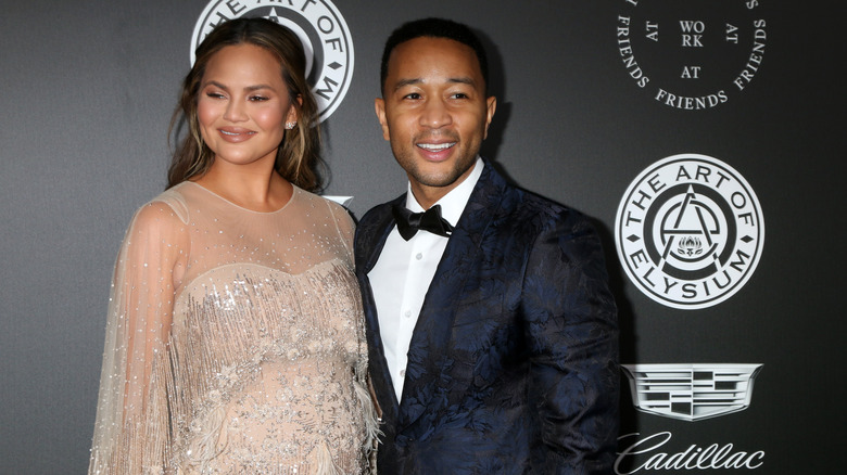 John Legend and Chrissy Teigen smile 