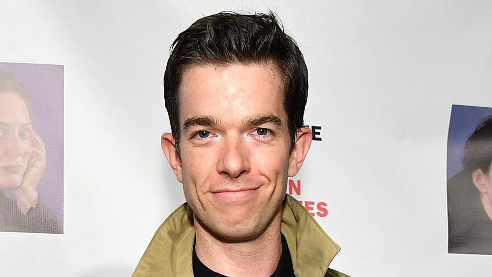 John Mulaney smirking