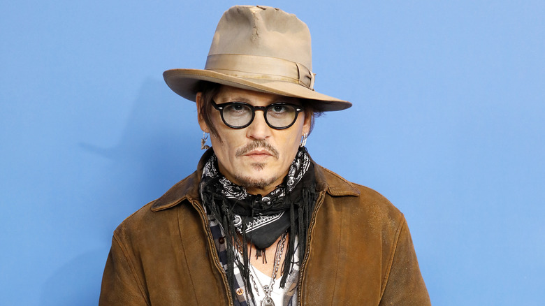 Johnny Depp poses in brown hat