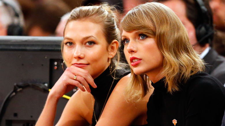 Karlie Kloss and Taylor Swift sitting 