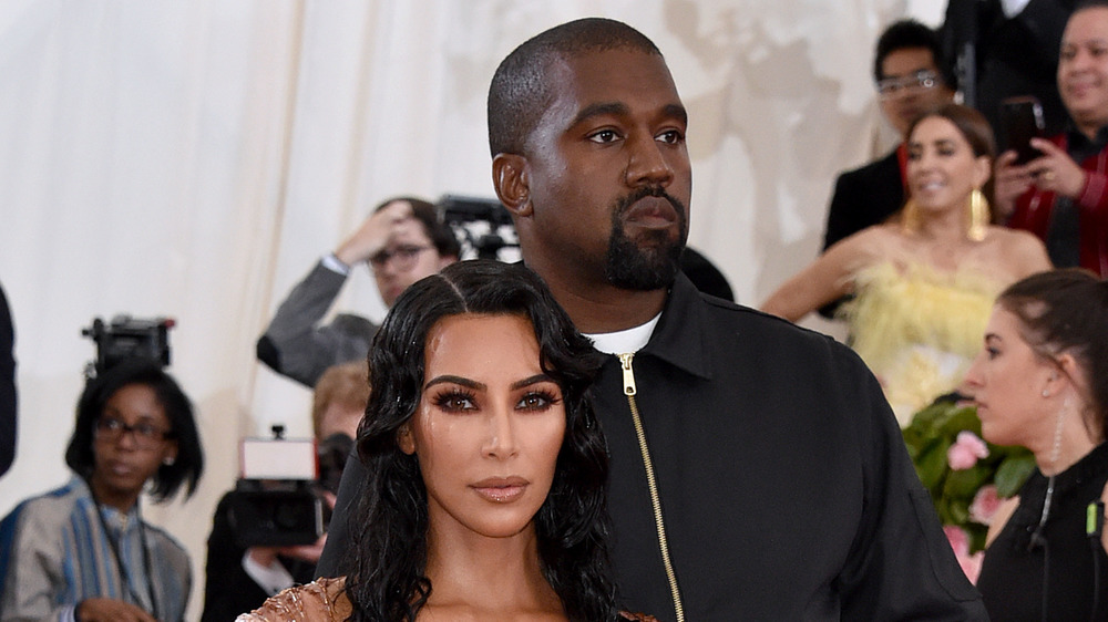 Kim Kardashian and Kanye West with neutral expressions