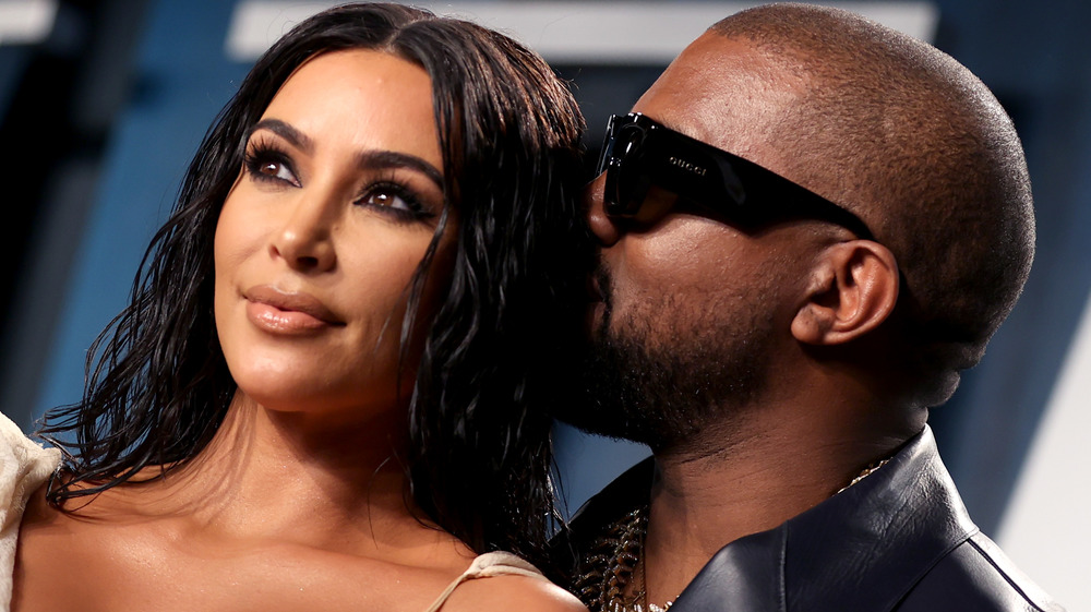 Kanye West gives Kim Kardashian a kiss on the head at the 2020 Vanity Fair Oscars party