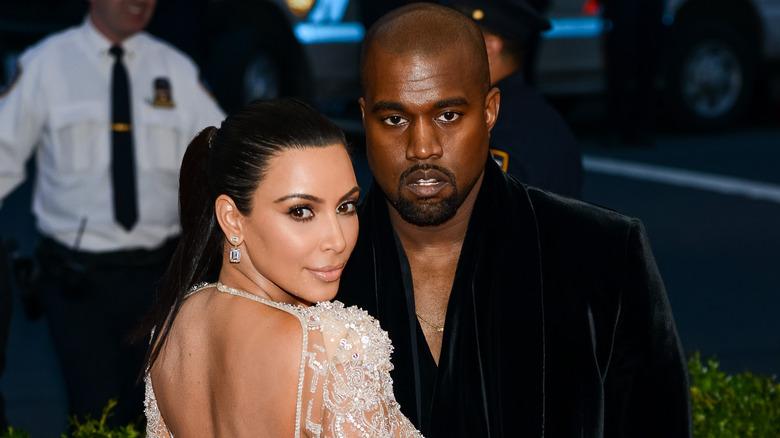 Kim Kardashian and Kanye "Ye" West posing for a picture