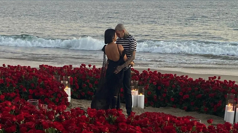 Kourtney kardashian hugging travis barker on beach 