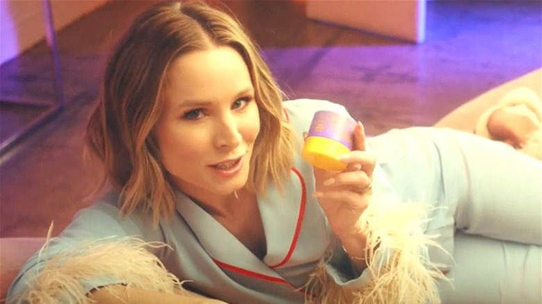 Kristen Bell holding skincare jar