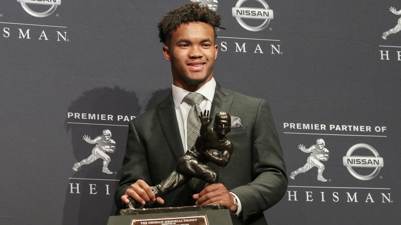 Kyler Murray holding Heisman trophy