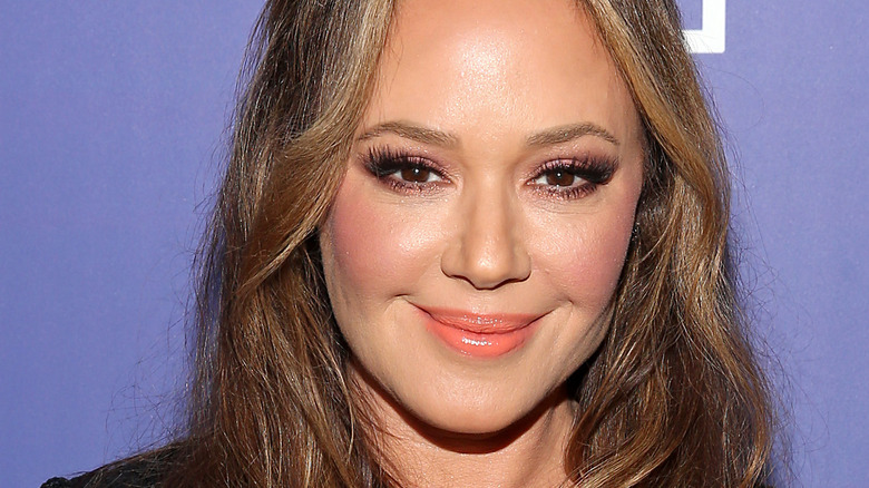 Leah Remini smiles on the red carpet