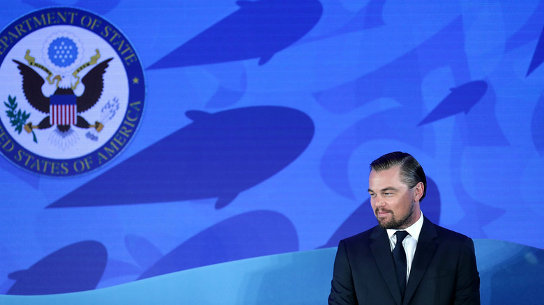 Leonardo DiCaprio making a speech in front of an ocean background