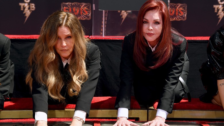 Lisa Marie Presley Priscilla Presley bent over looking miserable