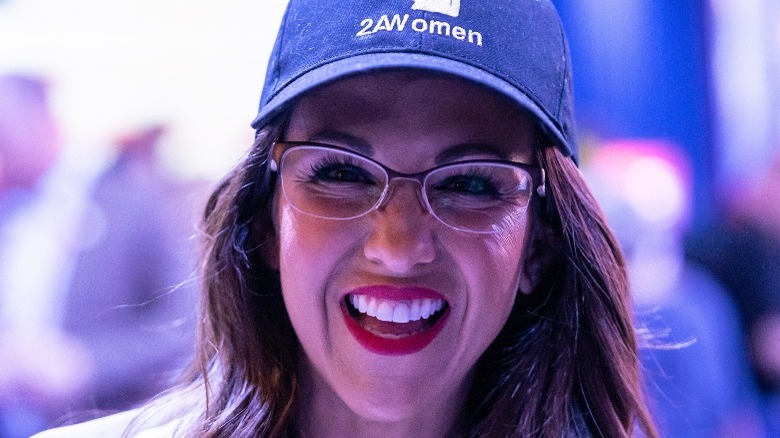 Lauren Boebert laughing in a baseball cap