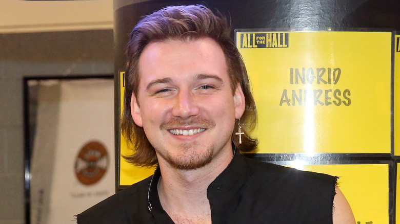 Morgan Wallen smiling on a red carpet