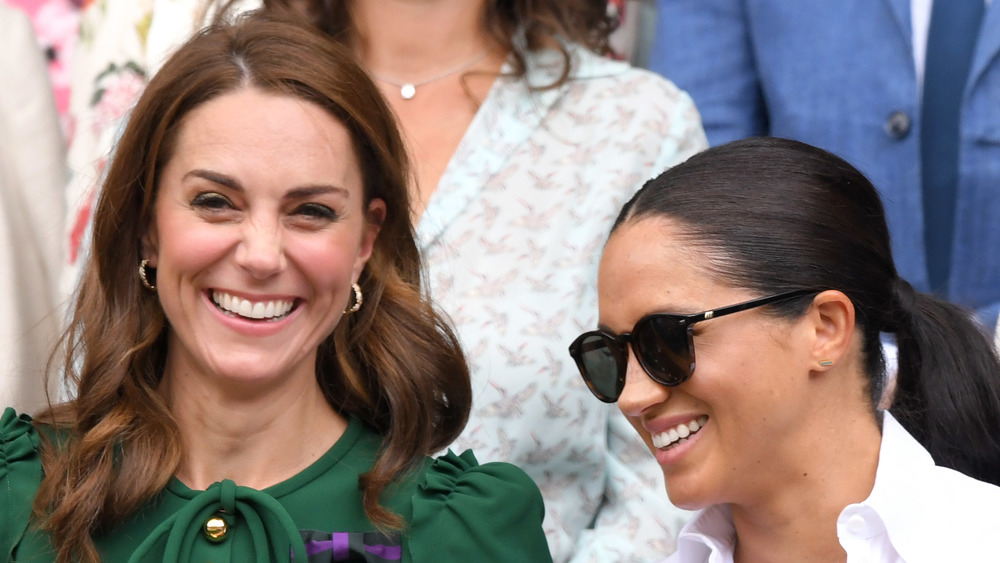 Duchess of Cambridge Kate Middleton & Duchess of Sussex Meghan Markle laughing at an event