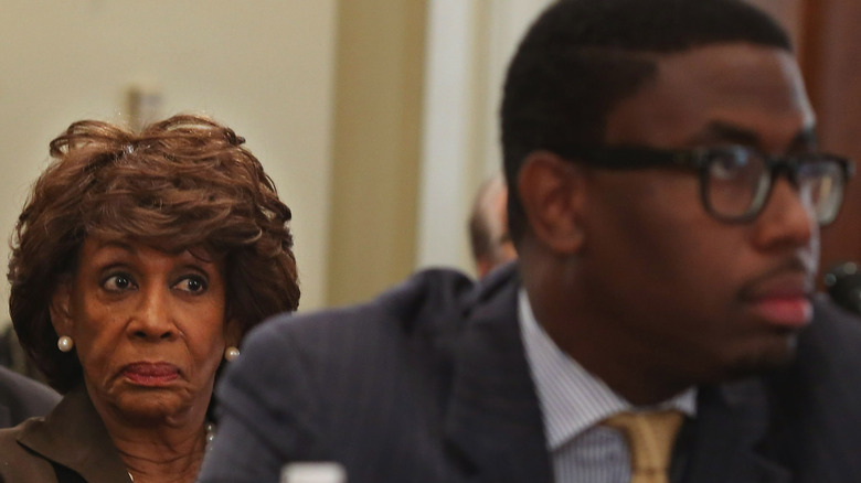 Maxine Waters looking at the back of Mikael Moore's head