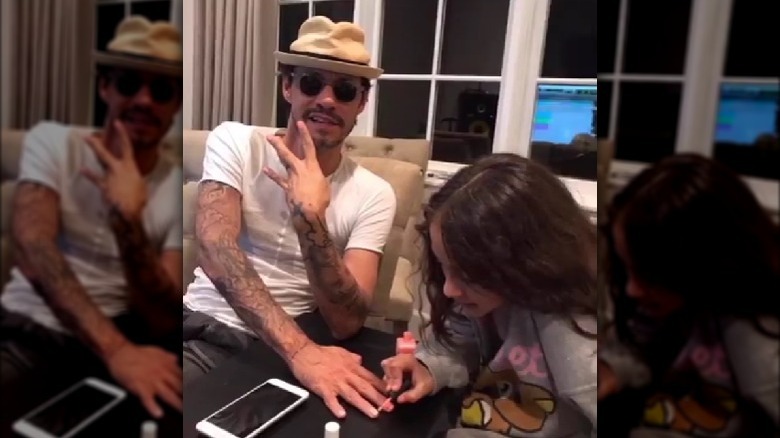 Emme Muniz painting Marc Anthony's nails