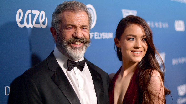 Mel Gibson and Rosalind Ross smiling on the red carpet