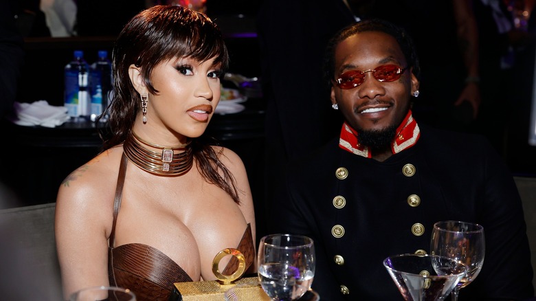 Cardi B and Offset sitting in front of drinking glasses